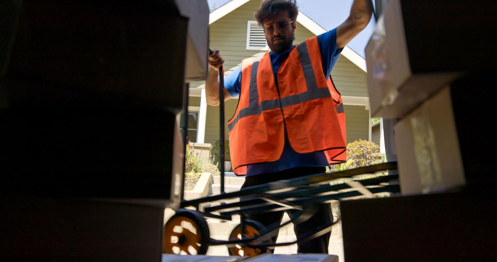 Delivery Person Opening Van Door in front of Suburban House